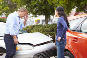 a man and woman arguing after a car accident 