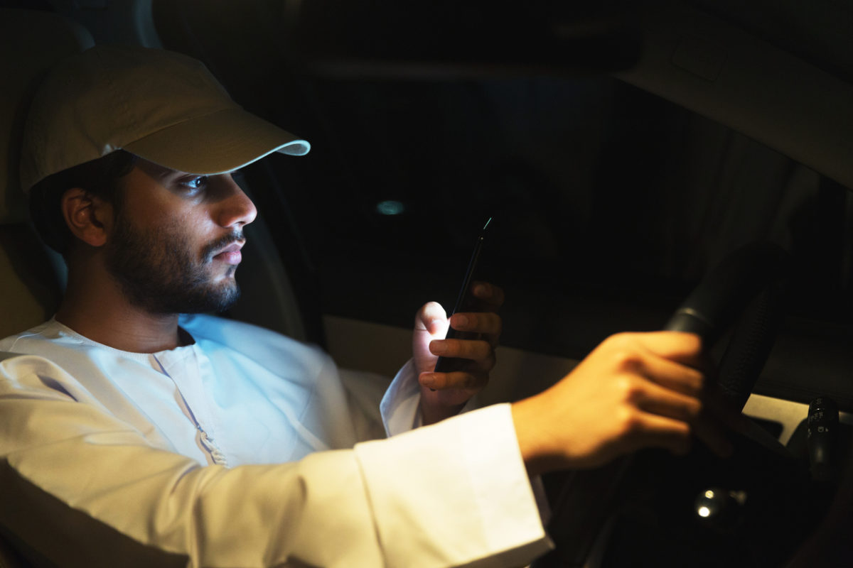 Distracted young man texting while driving